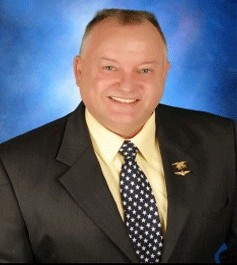 Portrait of attorney Mike Reiter in a dark suit and star-patterned tie